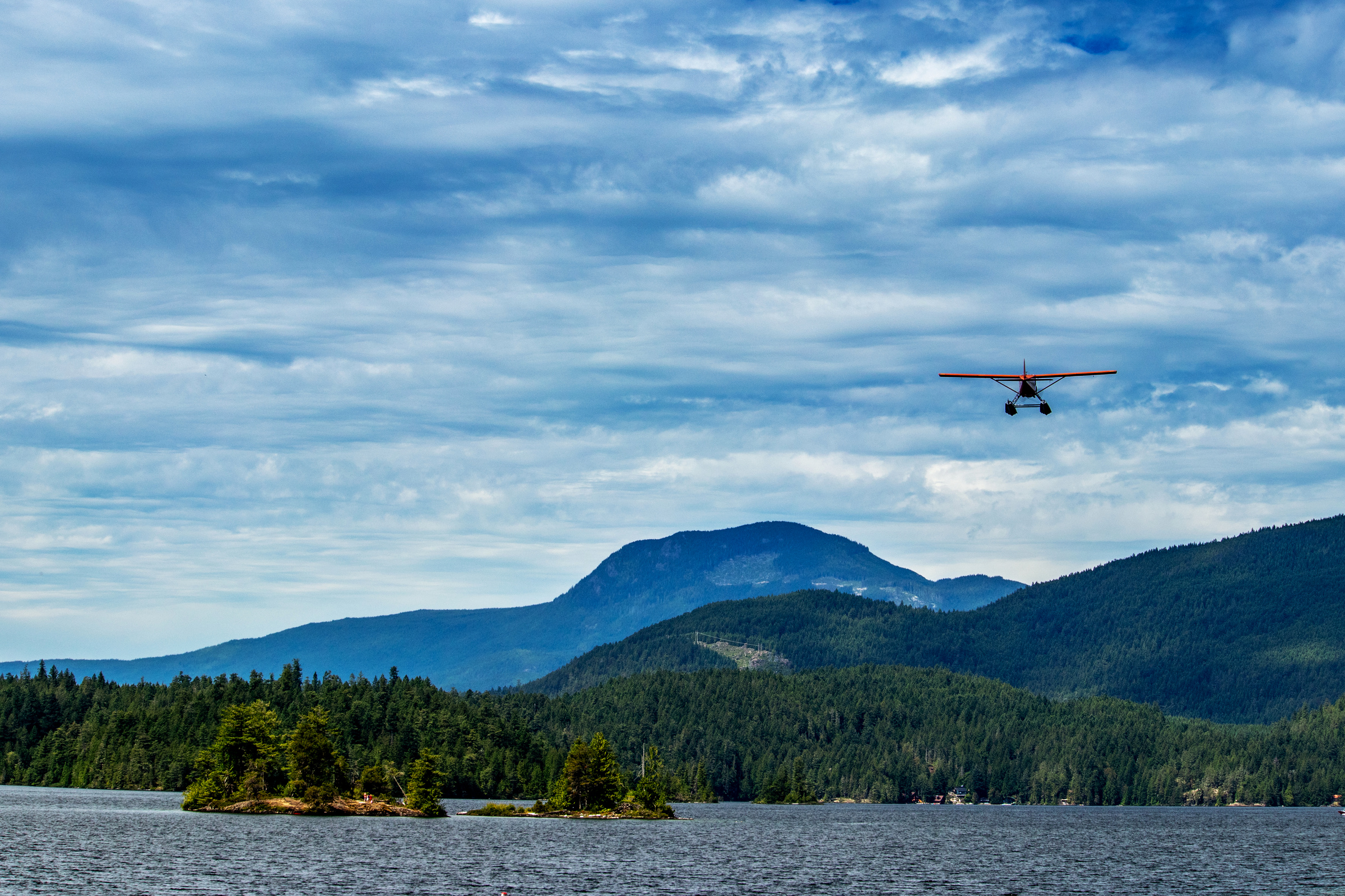Float plane flying above Ruby Lake, Sunshine Coast, BC, Canada